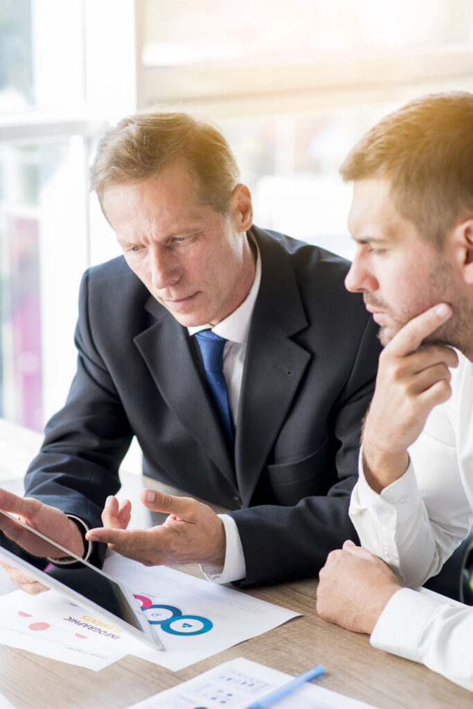 two businessman discussing business plan digital tablet